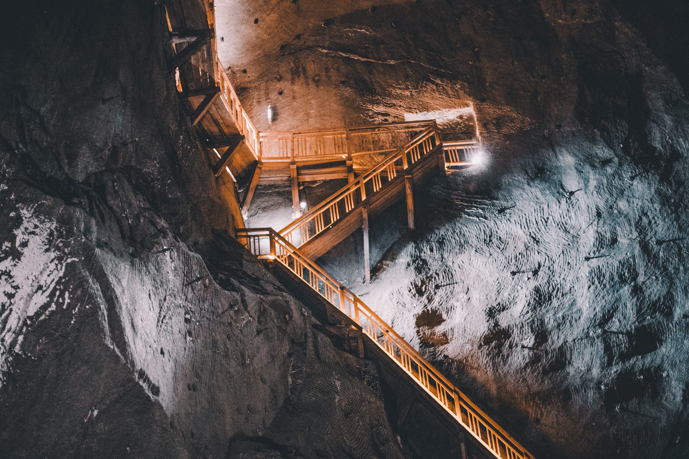 Underground mine stairway illuminated against exposed rock