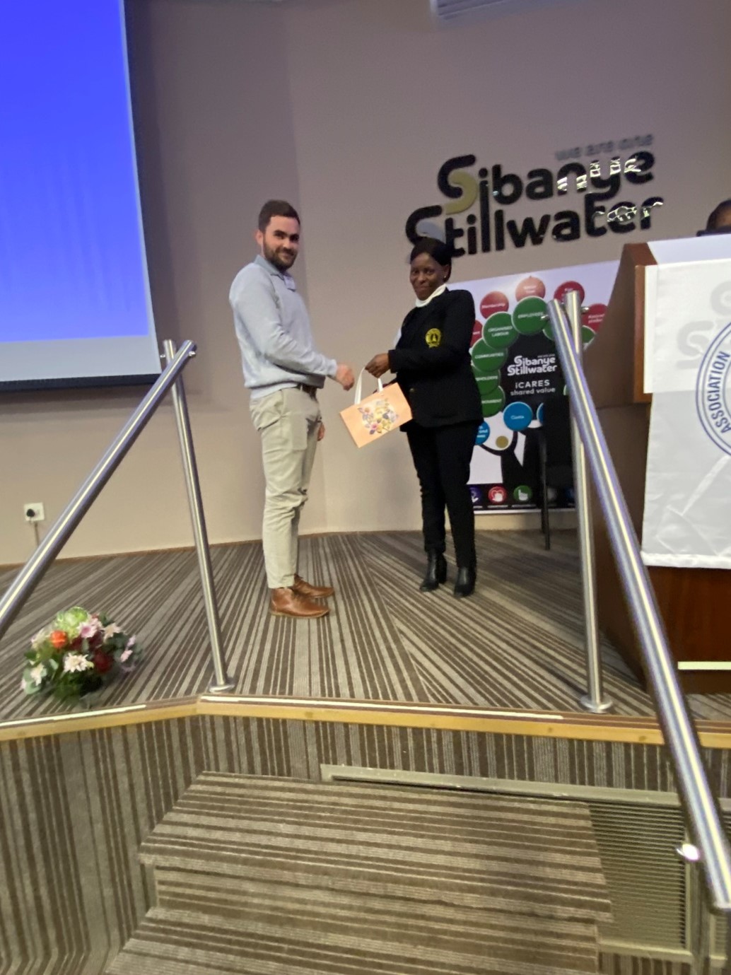 Luke van Eyk receiving a gift from an AMRE Safety Seminar organiser after his presentation