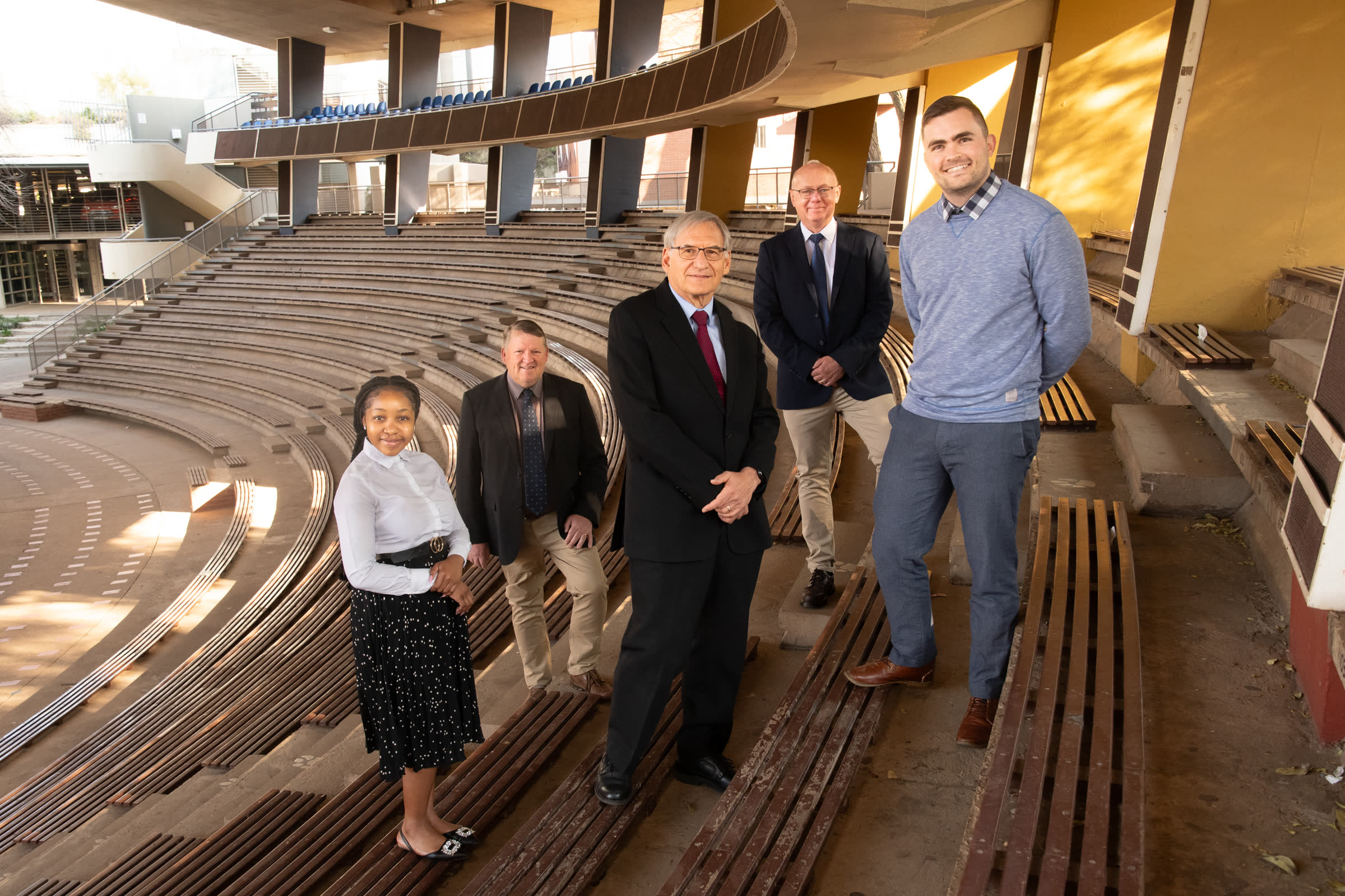 Five RAMMS team members standing in an outdoor University of Pretoria amphitheatre